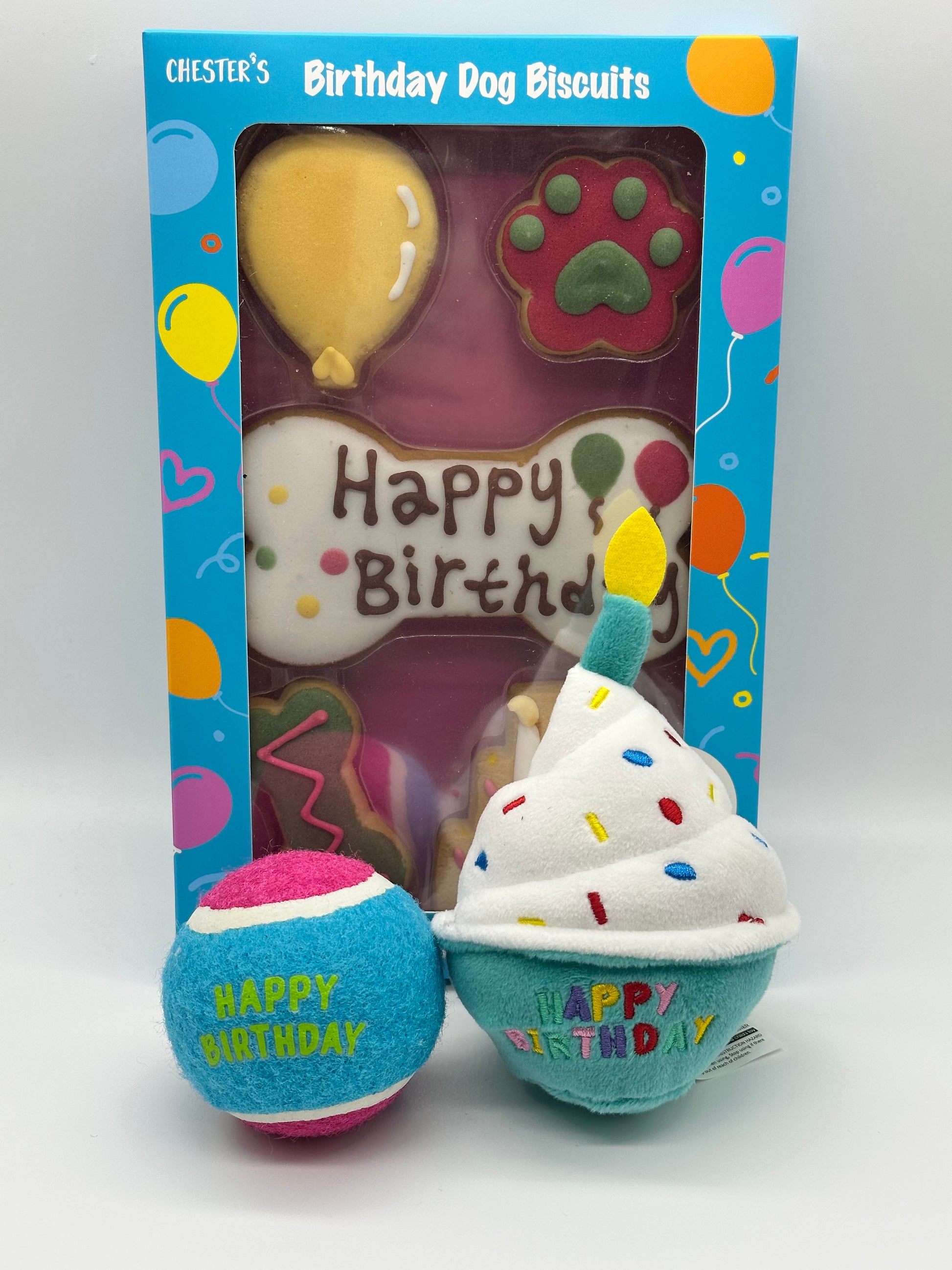 Dog birthday box with birthday biscuits, a soft squeaky cupcake and a ball