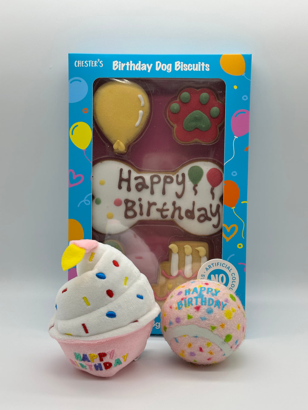 Dog birthday box with birthday biscuits, a soft squeaky cupcake and a ball