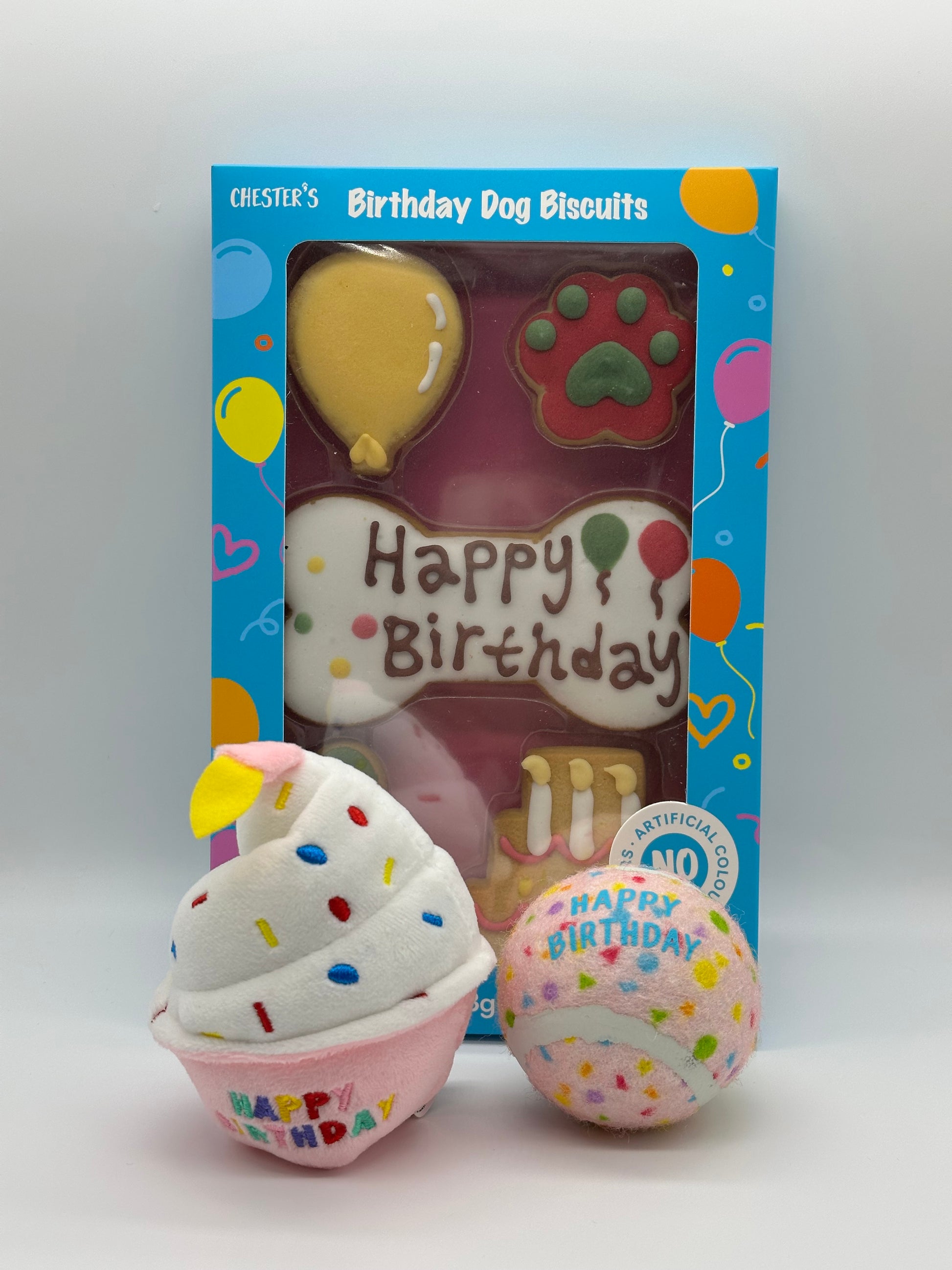 Dog birthday box with birthday biscuits, a soft squeaky cupcake and a ball